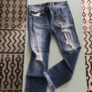 Black label very distressed denim, raw bottom